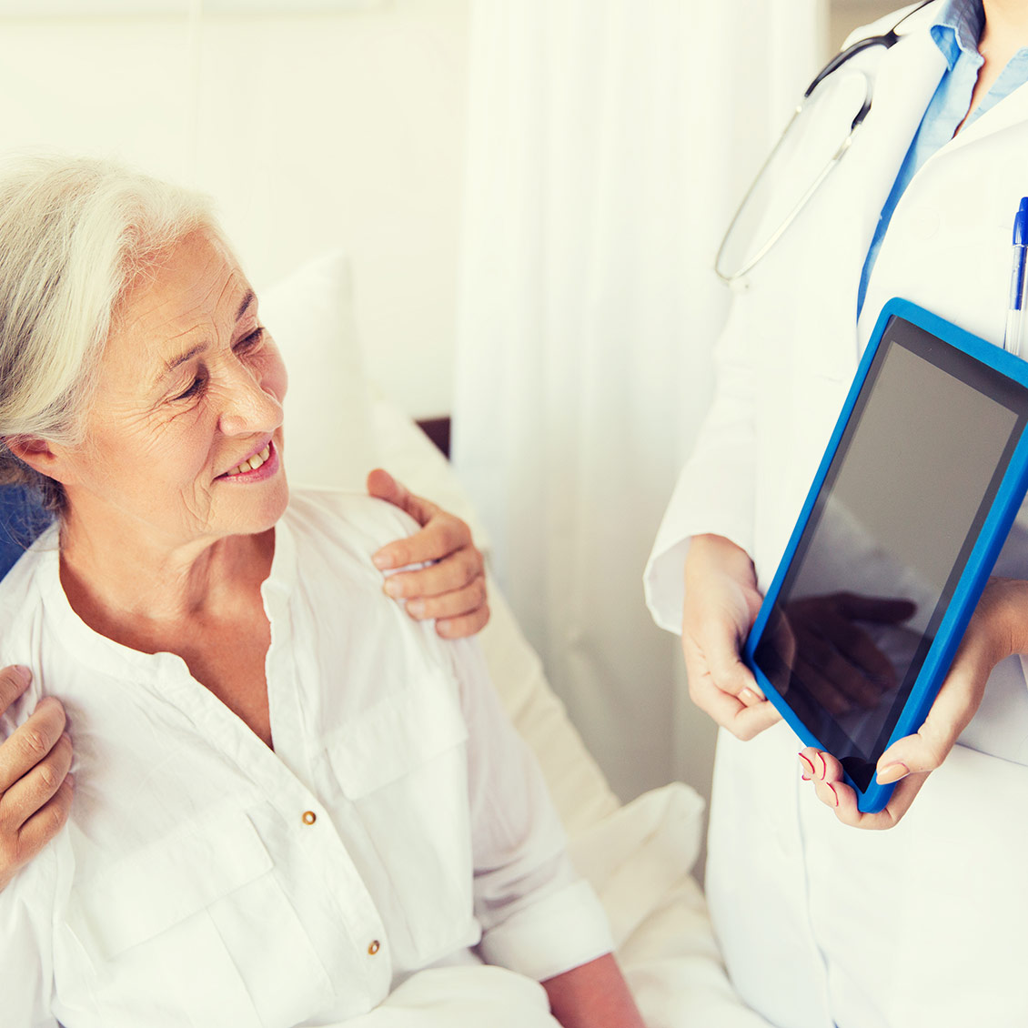 senior-woman-and-doctor-with-tablet-pc-at-hospital-1130×1130